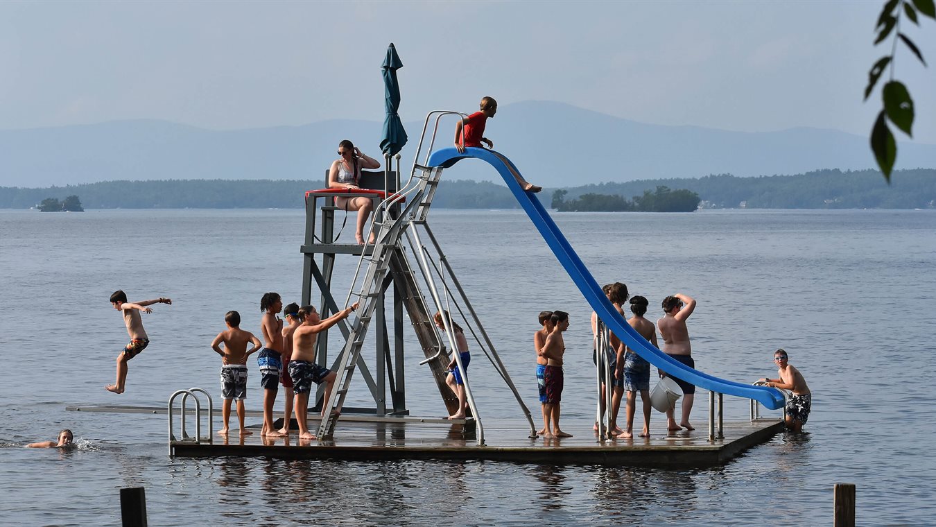 Boys playing on Lake Winnipesaukee with water slide
