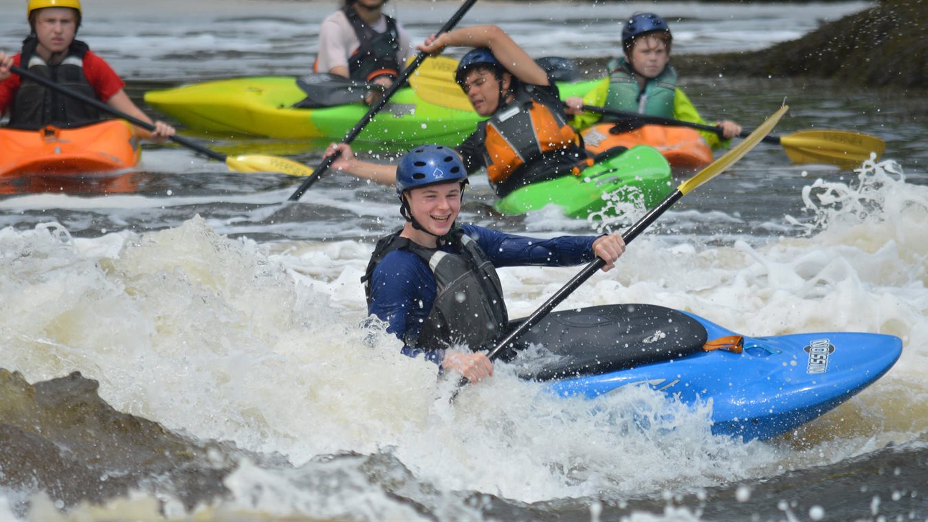 Boys whitewater kayaking