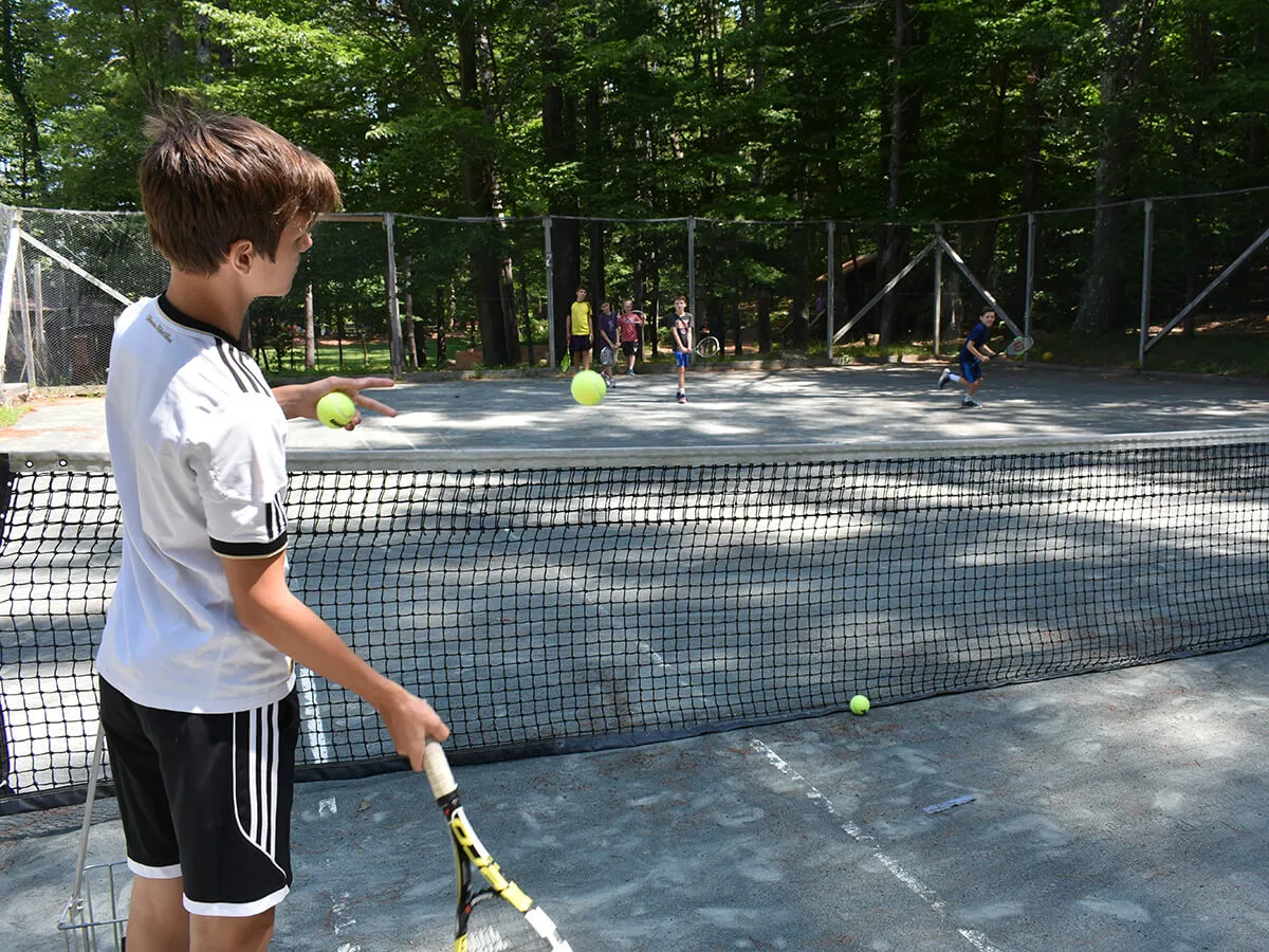 Boy playing tennis at Kabeyun 