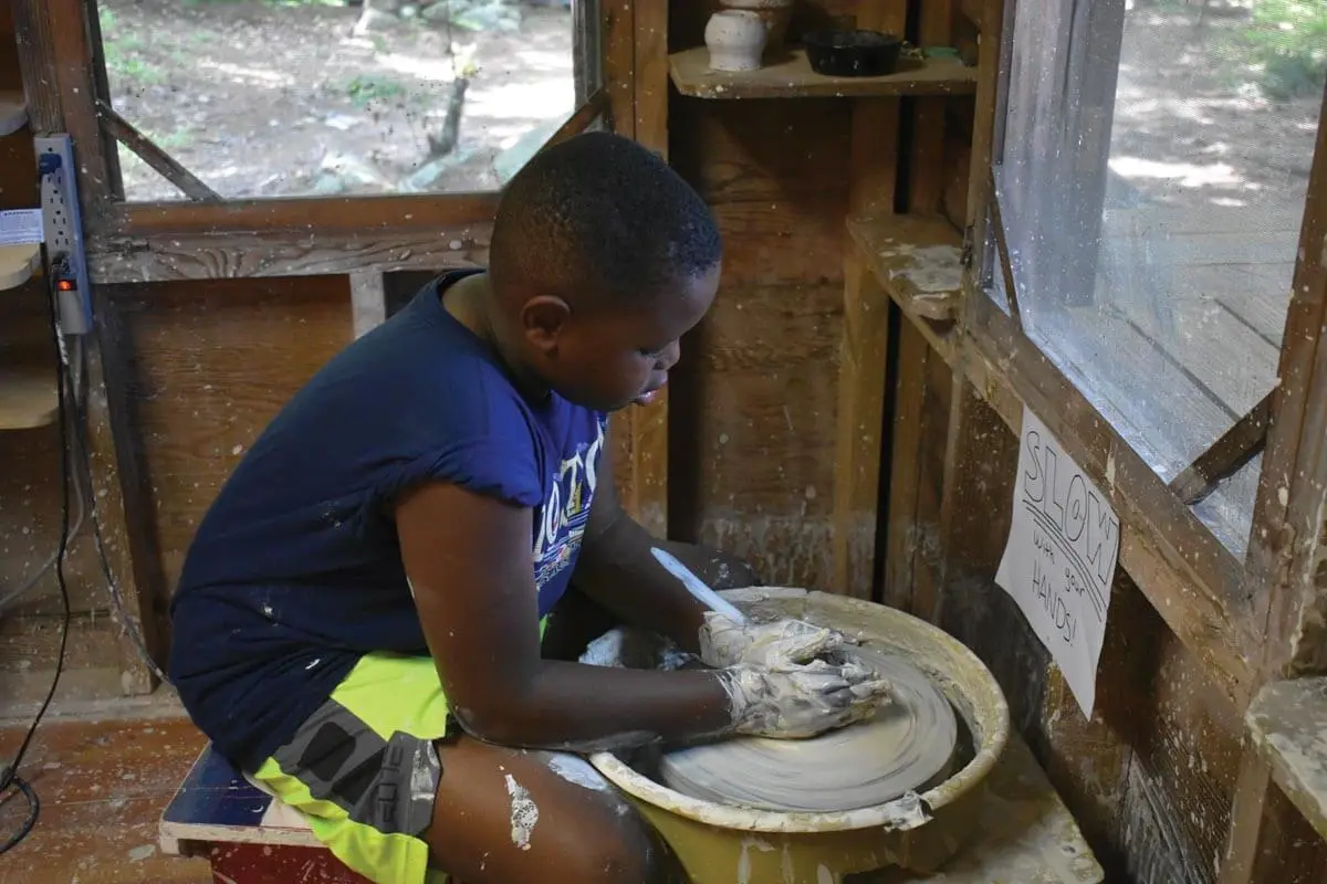 Young boy working on potter's wheel