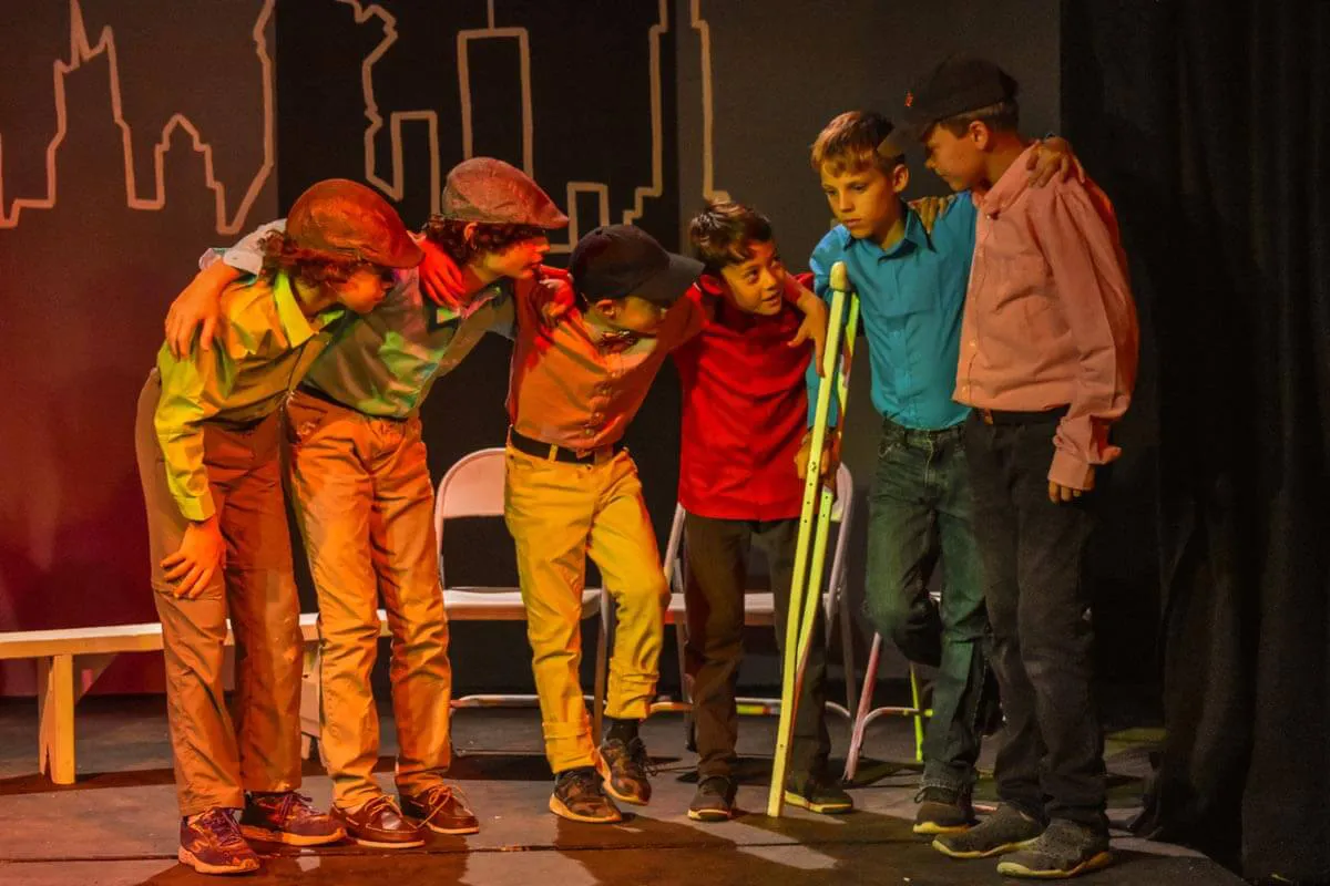 Group of boys participating in a drama production 