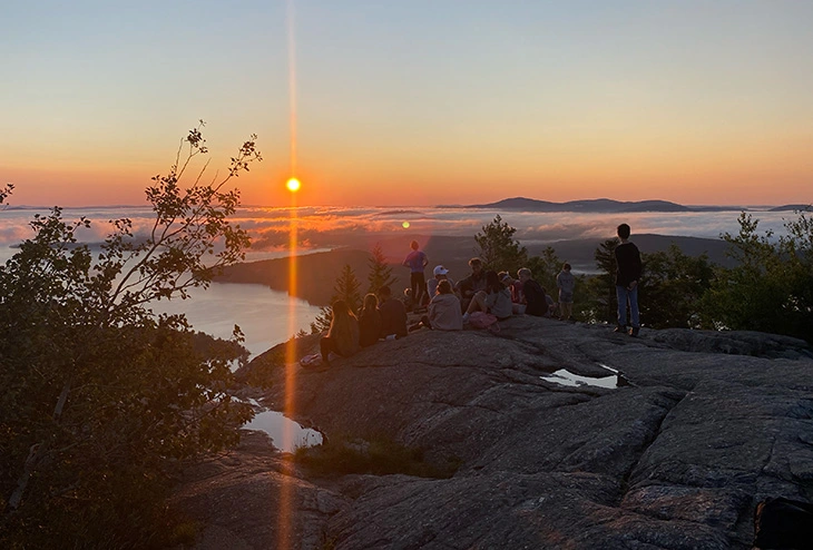 Boys watching sunrise on Lake Winnipesaukee